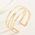 Handcrafted Gold-plated Geometric Cuff Bracelets And Boho-chic Metal Tassel Arm Rings With Vintage-inspired Exaggerated Water Drop Designs, Offering Unisex Luxury Accessories In Open Bangle Styles - Norellé