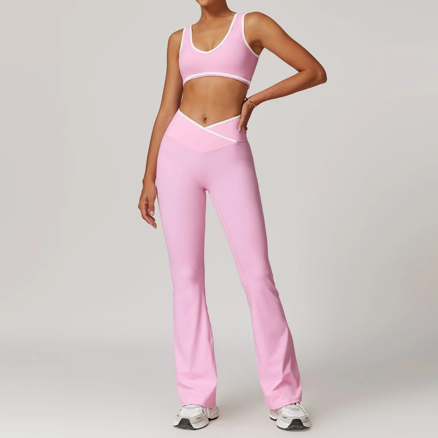 Pink athletic top and flared leggings set with white trim for workout outfits fitness