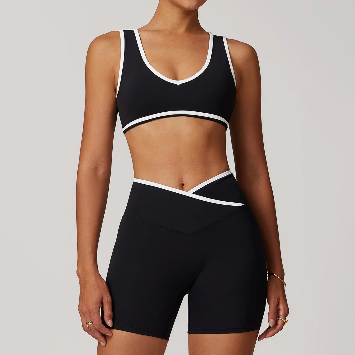 Black sports bra and biker shorts set with white trim from Blue-Grey Workout Outfit Fitness Sportswear