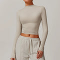 Light beige long sleeve crop top with mock neck, ideal for sports yoga long or running fitness wear