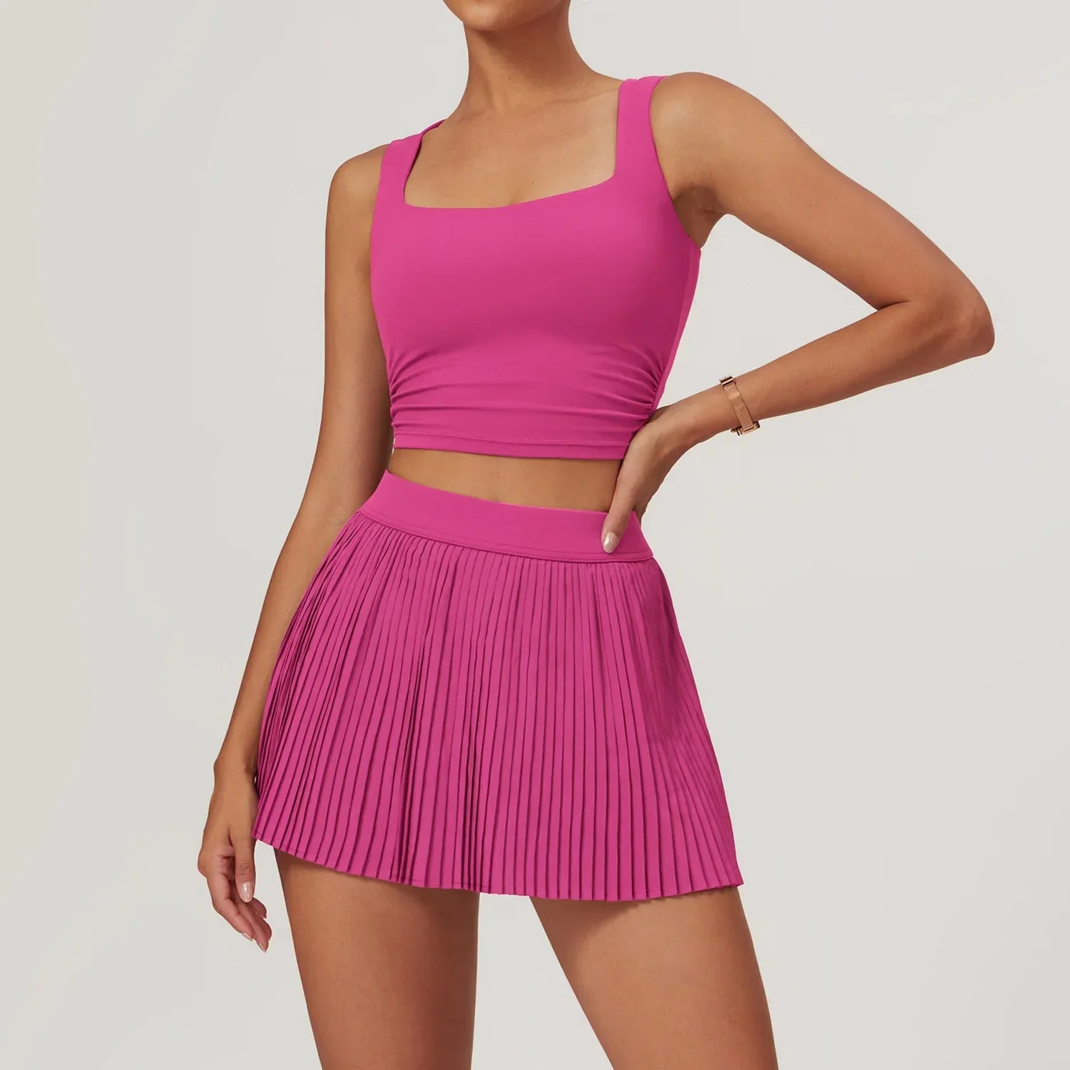 Fuchsia pink athletic 2pcs yoga set with pleated skirt and crop top