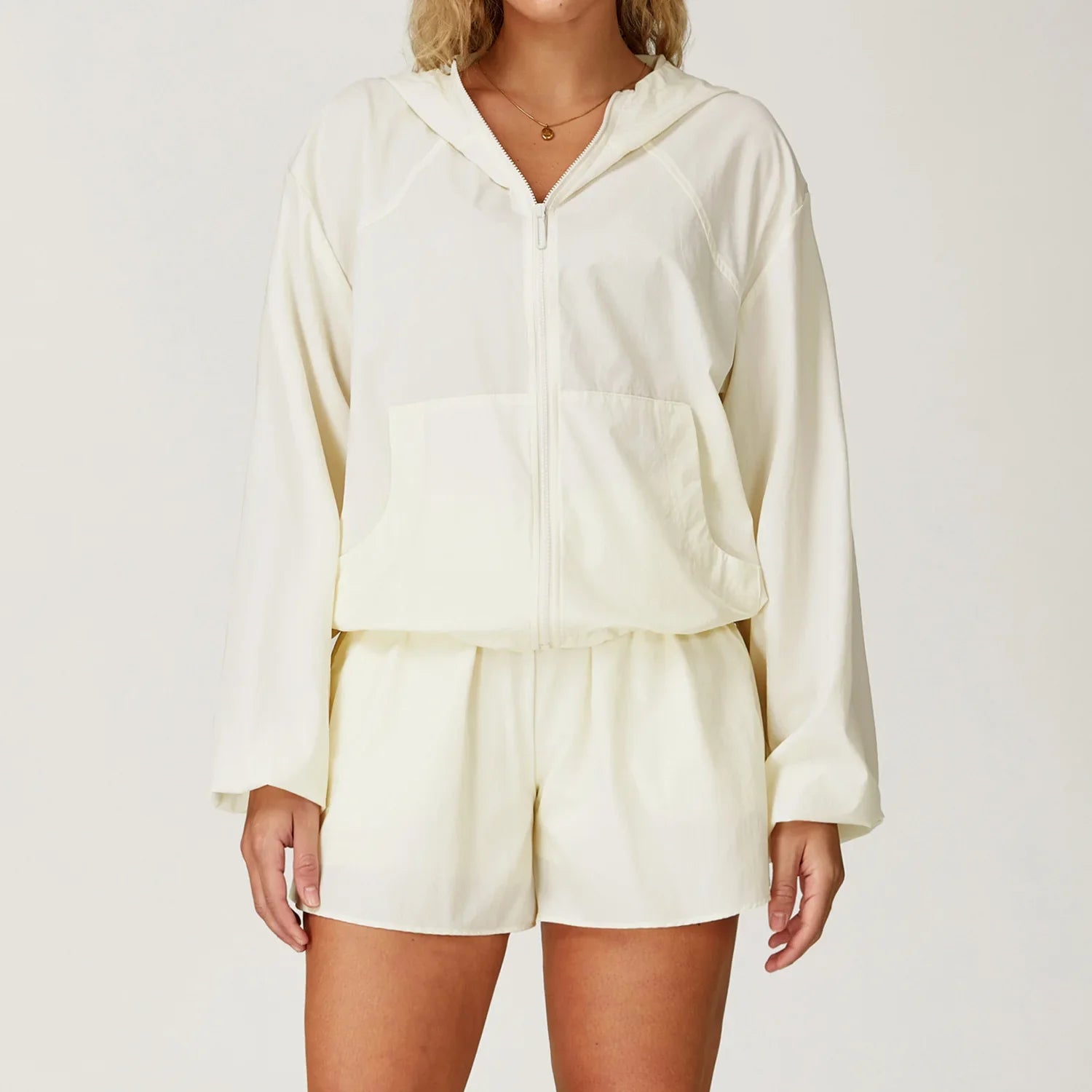 Off-white hooded windbreaker and matching shorts set for outdoor sports women
