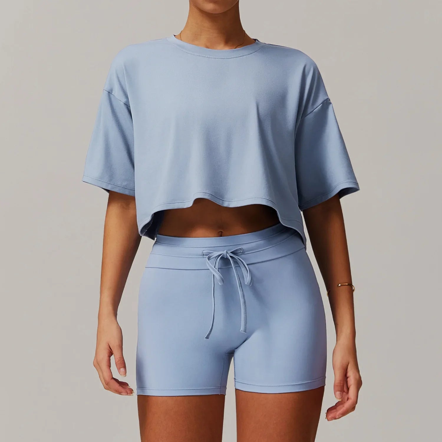 Light blue women’s sportswear 2pcs set featuring cropped t-shirt and biker shorts for women tracksuit yoga