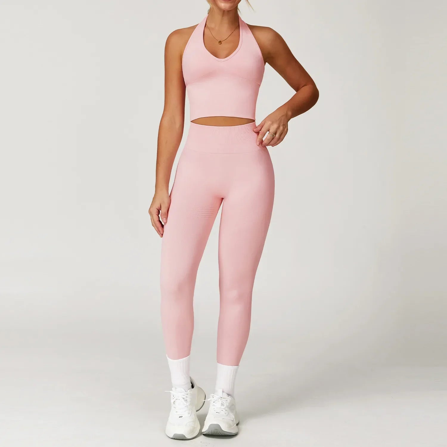 Light pink seamless gym set with halter crop top and high-waisted leggings