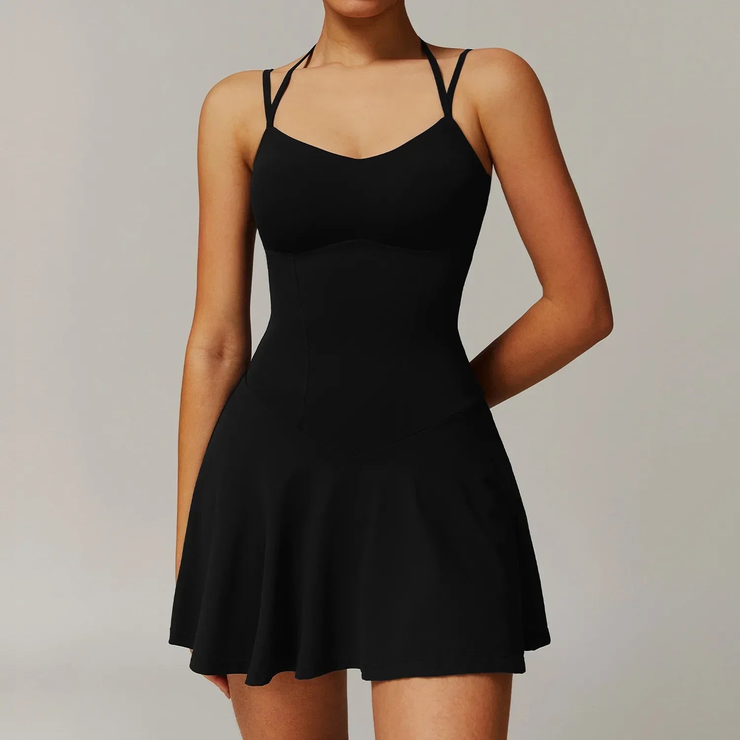 Off white strappy mini dress with black criss-cross straps and flared skirt