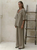Woman in olive green linen sleeved pants set with white bralette