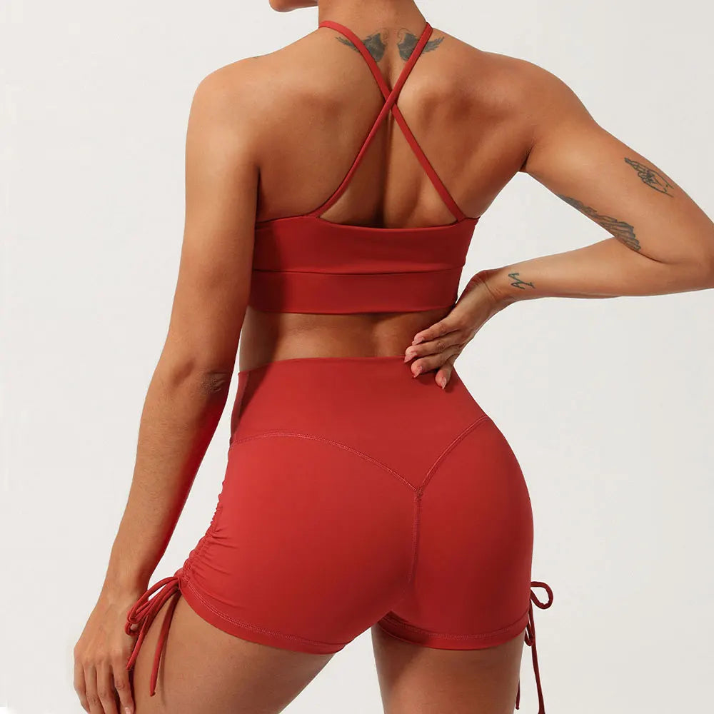 Rust halter neck yoga set with high-waisted ruched shorts