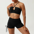 Rust halter neck yoga set with black high-waisted ruched shorts