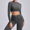 Seamless yoga long sleeve cropped top in light cream with gray leggings