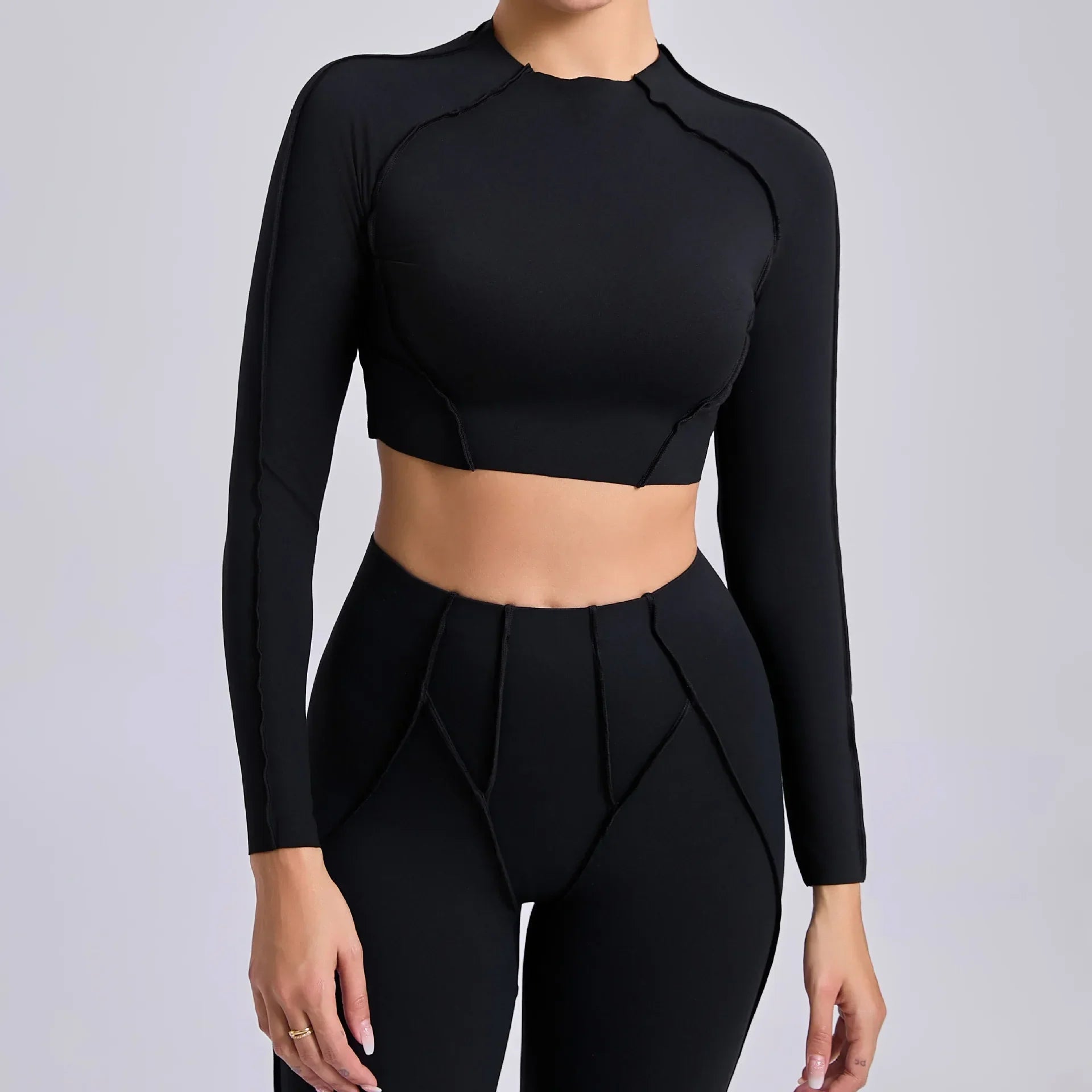 Light cream seamless yoga long sleeve cropped top with black leggings