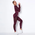 Seamless yoga set with ribbed maroon crop top and high-waisted leggings