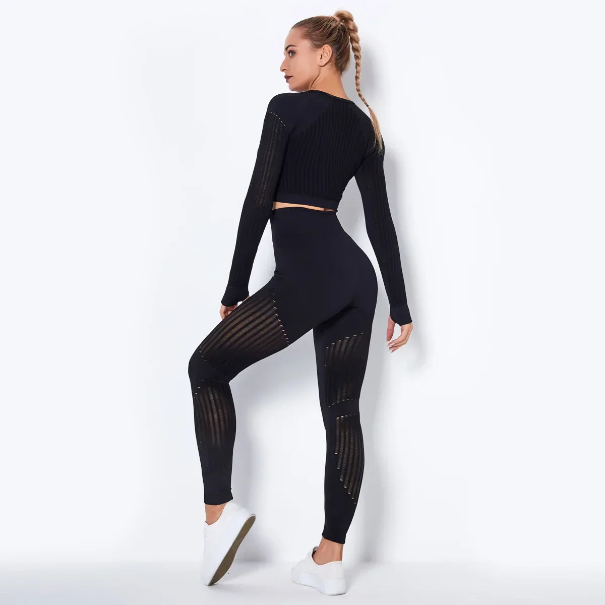 Woman in seamless yoga set: ribbed crop top and high-waisted leggings