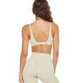 Woman in beige stretchy soft training set with compression and quick dry fabric