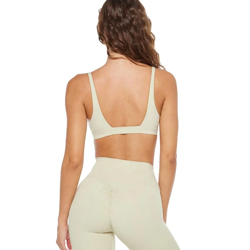 Woman in beige stretchy soft training set with compression and quick dry fabric