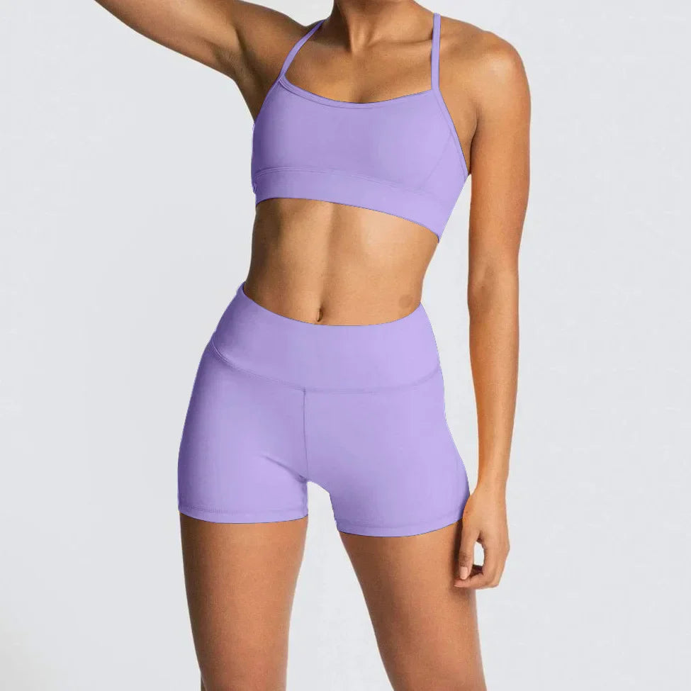 Woman in lavender 2pcs yoga set gym suit with athletic bra and shorts
