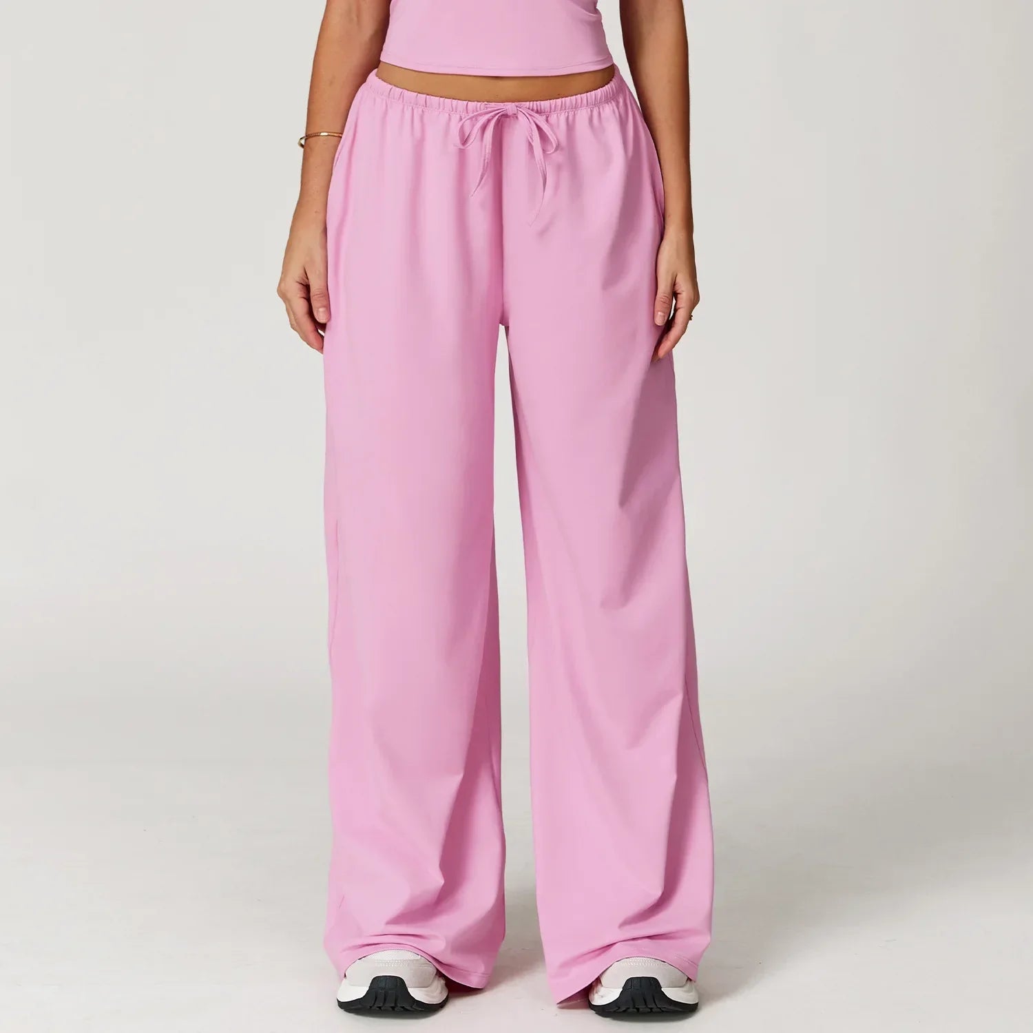 Women lilac wide leg sweatpants with high waist drawstring and sneakers